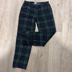 Stars above woman’s soft plaid pajama bottoms